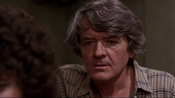 Movie still from “Creepshow” (1982), directed by George A. Romero – An older man with grey hair looking at the camera; Close Up shot, Over the shoulder angle