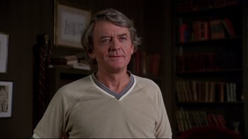 Movie still from “Creepshow” (1982), directed by George A. Romero – An older man with grey hair wearing a beige shirt; Close Up shot, Low angle