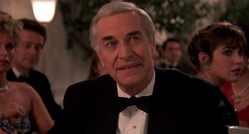 Movie still from “Crimes and Misdemeanors” (1989), directed by Woody Allen – An older man wearing a tuxedo and a bow tie; Close Up shot, Low angle