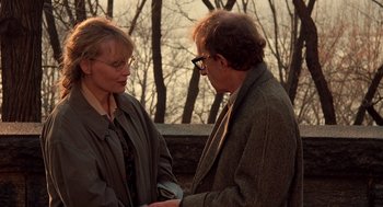 Movie still from “Crimes and Misdemeanors” (1989), directed by Woody Allen – A man and a woman standing next to each other outside; Medium shot, Over the shoulder angle