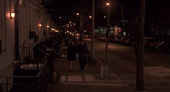 Movie still from “Crimes and Misdemeanors” (1989), directed by Woody Allen – Two people walking down a sidewalk at night; Wide shot, High angle