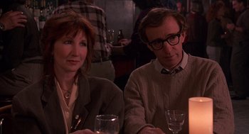 Movie still from “Crimes and Misdemeanors” (1989), directed by Woody Allen – A man and a woman sitting at a dinner table; Medium shot, Over the shoulder angle