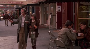 Movie still from “Crimes and Misdemeanors” (1989), directed by Woody Allen – A man and a woman walking down a sidewalk; Wide shot, Over the shoulder angle