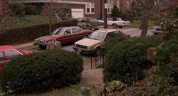 Movie still from “Crimes and Misdemeanors” (1989), directed by Woody Allen – A man standing in front of some cars; Extreme Wide shot, High angle