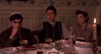 Movie still from “Crimes and Misdemeanors” (1989), directed by Woody Allen – A group of people sitting at a dinner table; Medium shot, High angle