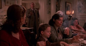 Movie still from “Crimes and Misdemeanors” (1989), directed by Woody Allen – An older man and a young boy sitting in front of a woman; Medium shot, Over the shoulder angle