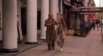 Movie still from “Crimes and Misdemeanors” (1989), directed by Woody Allen – A man and a woman walking down the sidewalk; Wide shot, High angle
