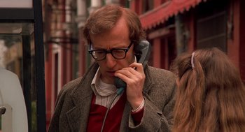 Movie still from “Crimes and Misdemeanors” (1989), directed by Woody Allen – A man with glasses is talking on a phone; Close Up shot, High angle