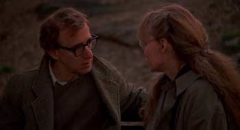Movie still from “Crimes and Misdemeanors” (1989), directed by Woody Allen – A man and a woman sitting next to each other on a bench; Close Up shot, Over the shoulder angle