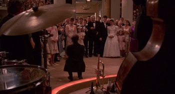 Movie still from “Crimes and Misdemeanors” (1989), directed by Woody Allen – A group of people standing in a room; Wide shot, High angle