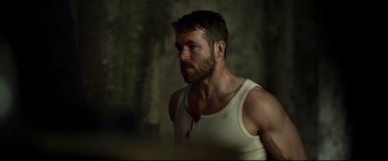 Movie still from “Criminal” (2016), directed by Ariel Vromen – A person with blood on his face; Medium shot, Over the shoulder angle