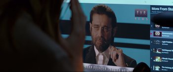 Movie still from “Criminal” (2016), directed by Ariel Vromen – A man in a suit and tie looking into a mirror; Close Up shot, Over the shoulder angle