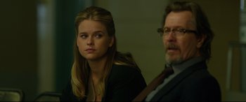 Movie still from “Criminal” (2016), directed by Ariel Vromen – A woman sitting next to a man in front of a wall; Close Up shot, Over the shoulder angle