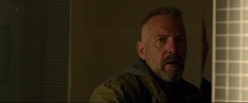 Movie still from “Criminal” (2016), directed by Ariel Vromen – A person wearing a jacket; Close Up shot, Low angle