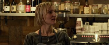 Movie still from “Criminal” (2016), directed by Ariel Vromen – A woman wearing an apron in front of a counter; Close Up shot, Over the shoulder angle