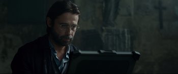 Movie still from “Criminal” (2016), directed by Ariel Vromen – A man sitting in front of a computer; Close Up shot, Low angle