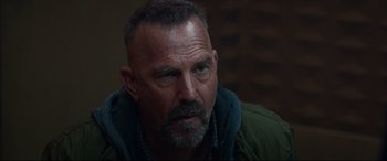 Movie still from “Criminal” (2016), directed by Ariel Vromen – A person wearing a jacket; Close Up shot, Over the shoulder angle