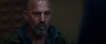 Movie still from “Criminal” (2016), directed by Ariel Vromen – A person wearing a jacket; Close Up shot, Over the shoulder angle