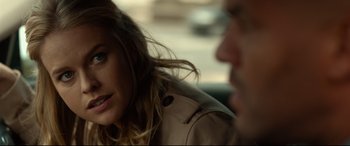 Movie still from “Criminal” (2016), directed by Ariel Vromen – A man and a woman sitting next to each other in a car; Close Up shot, Over the shoulder angle