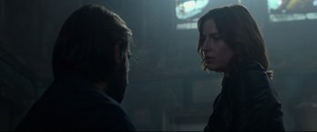 Movie still from “Criminal” (2016), directed by Ariel Vromen – A man and a woman standing next to each other in a room; Close Up shot, Over the shoulder angle