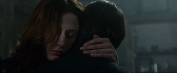 Movie still from “Criminal” (2016), directed by Ariel Vromen – A woman and a man hugging in a dark room; Close Up shot, Over the shoulder angle