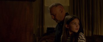 Movie still from “Criminal” (2016), directed by Ariel Vromen – An older man and a young girl looking at something on a table; Close Up shot, Over the shoulder angle