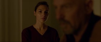 Movie still from “Criminal” (2016), directed by Ariel Vromen – A woman looking into a mirror while standing next to a man; Close Up shot, Over the shoulder angle