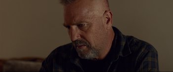 Movie still from “Criminal” (2016), directed by Ariel Vromen – A person with a beard; Close Up shot, Low angle