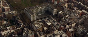 Movie still from “Criminal” (2016), directed by Ariel Vromen – An aerial view of an industrial building in a city; Extreme Wide shot, High angle