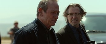 Movie still from “Criminal” (2016), directed by Ariel Vromen – Two men standing next to each other on top of a hill; Close Up shot, Over the shoulder angle