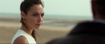 Movie still from “Criminal” (2016), directed by Ariel Vromen – A person on a beach; Close Up shot, Over the shoulder angle