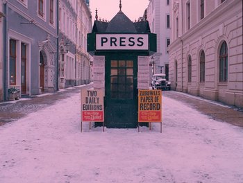 Movie still from “The Grand Budapest Hotel” (2014), directed by Wes Anderson – A newspaper stand on the side of the street; Extreme Wide shot, High angle