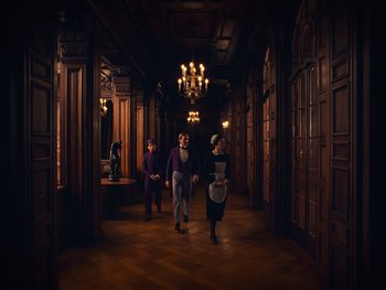 Movie still from “The Grand Budapest Hotel” (2014), directed by Wes Anderson – A group of people walking down a hall way; Wide shot, Low angle