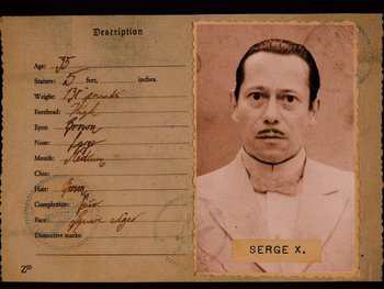 Movie still from “The Grand Budapest Hotel” (2014), directed by Wes Anderson – An old photo of a man in a white suit; Extreme Close Up shot, Overhead angle