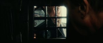 Movie still from “Crimson Rivers 2: Angels of the Apocalypse” (2004), directed by Olivier Dahan – A man looking through a jail cell window; Extreme Close Up shot, Overhead angle