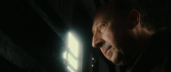 Movie still from “Crimson Rivers 2: Angels of the Apocalypse” (2004), directed by Olivier Dahan – An older man looking out of a window at night; Close Up shot, Low angle