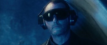 Movie still from “Crimson Rivers 2: Angels of the Apocalypse” (2004), directed by Olivier Dahan – A man wearing headphones and wearing a jacket; Close Up shot, High angle