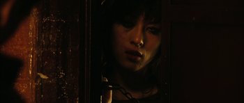 Movie still from “Crimson Rivers 2: Angels of the Apocalypse” (2004), directed by Olivier Dahan – A woman with a chain around her neck; Close Up shot, Low angle
