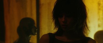 Movie still from “Crimson Rivers 2: Angels of the Apocalypse” (2004), directed by Olivier Dahan – A woman with dark hair is looking at the camera; Close Up shot, Over the shoulder angle