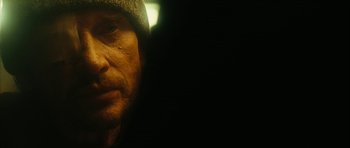 Movie still from “Crimson Rivers 2: Angels of the Apocalypse” (2004), directed by Olivier Dahan – A person wearing a hat; Extreme Close Up shot, Over the shoulder angle