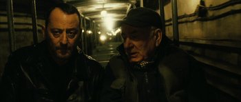 Movie still from “Crimson Rivers 2: Angels of the Apocalypse” (2004), directed by Olivier Dahan – Two men standing next to each other on a street; Close Up shot, Over the shoulder angle