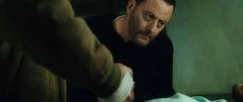 Movie still from “Crimson Rivers 2: Angels of the Apocalypse” (2004), directed by Olivier Dahan – A person with a hand on a pillow; Close Up shot, Over the shoulder angle