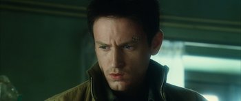 Movie still from “Crimson Rivers 2: Angels of the Apocalypse” (2004), directed by Olivier Dahan – A person with a face tattoo; Close Up shot, Low angle