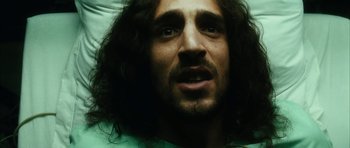 Movie still from “Crimson Rivers 2: Angels of the Apocalypse” (2004), directed by Olivier Dahan – A person with long curly hair; Close Up shot, Low angle