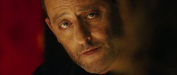 Movie still from “Crimson Rivers 2: Angels of the Apocalypse” (2004), directed by Olivier Dahan – A man's face in a dimly - lit room; Close Up shot, Over the shoulder angle
