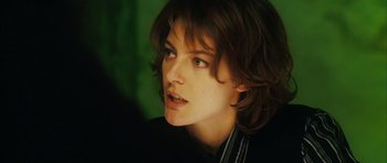 Movie still from “Crimson Rivers 2: Angels of the Apocalypse” (2004), directed by Olivier Dahan – A person with long brown hair; Close Up shot, Over the shoulder angle