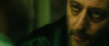 Movie still from “Crimson Rivers 2: Angels of the Apocalypse” (2004), directed by Olivier Dahan – A man's face in a green jacket; Close Up shot, Over the shoulder angle