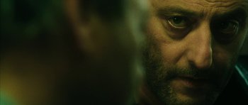 Movie still from “Crimson Rivers 2: Angels of the Apocalypse” (2004), directed by Olivier Dahan – A man's face in a dark room; Extreme Close Up shot, Over the shoulder angle