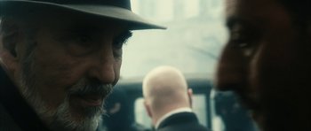 Movie still from “Crimson Rivers 2: Angels of the Apocalypse” (2004), directed by Olivier Dahan – A person wearing a hat; Close Up shot, Over the shoulder angle