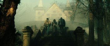 Movie still from “Crimson Rivers 2: Angels of the Apocalypse” (2004), directed by Olivier Dahan – A group of people walking up a set of stairs; Extreme Wide shot, Low angle